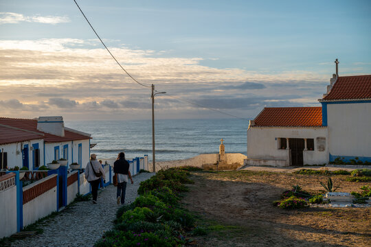 Two women on a walk trough small village by Atlantic Ocean