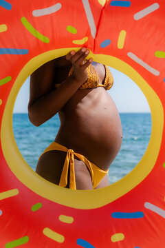 Pregnant woman with swim ring 