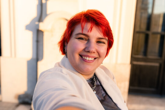 Smiling plus size woman making selfie in the city 