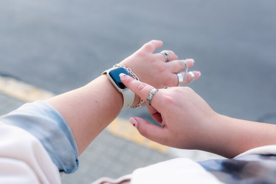 Woman using smartwatch outdoors 