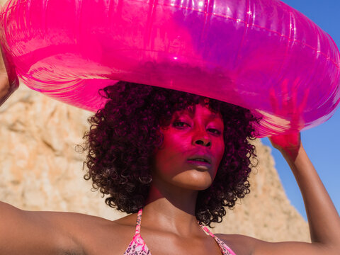 Gorgeous black woman with swim ring at beach 