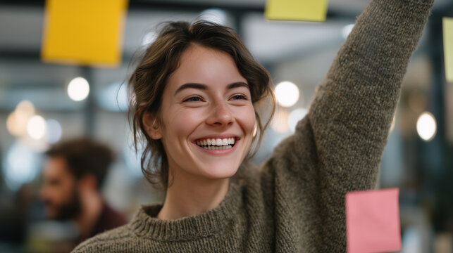 Marketing team brainstorm escalating into creative chaos &mdash; sticky notes falling off a glass wall, a young woman catching them while laughing, colleagues in animated discussion, spring afternoon in o