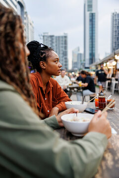 Friends get interrupted during meal together
