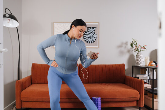 A woman does gymnastics at home