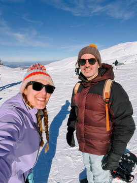 Couple selfie skiing and snowboarding