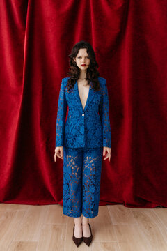 Woman standing in blue lace suit