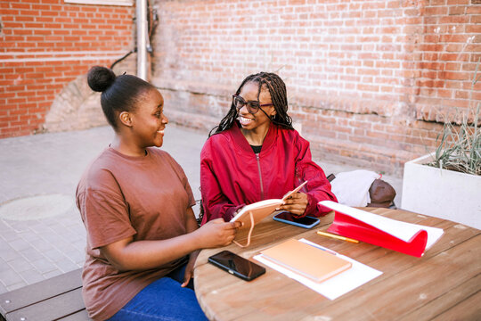 Friends exercise together outside.