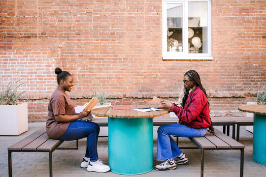 Friends exercise together outside.