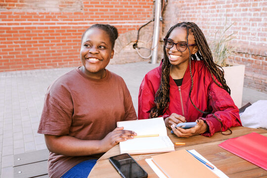 Friends exercise together outside.