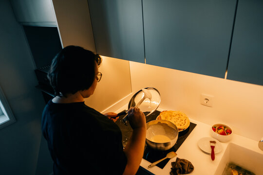 Preparing Pancakes in a Modern Kitchen at Breakfast Time