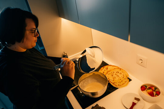 Woman Cooking Pancakes in Kitchen 
