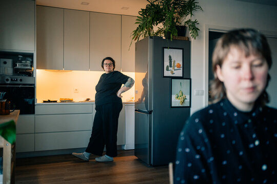 Two People in a Kitchen Preparing Food at Home in the Evening