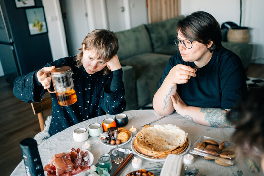 A couple Enjoying Tea and Food at a Round Table