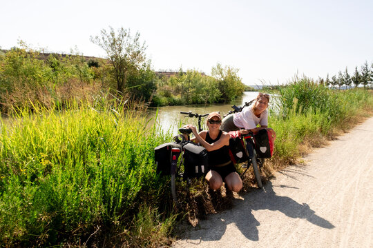 UGC sisters on bikepacking trip by riverside