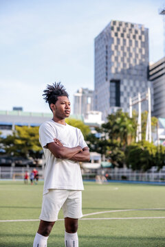 Rugby player stands on field