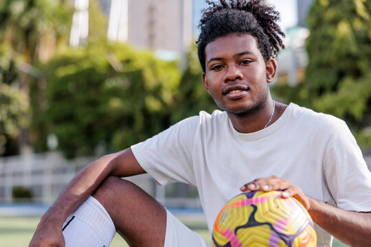 Soccer player poses with ball