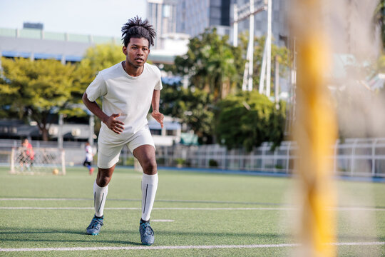 Young athlete sprints on the field.