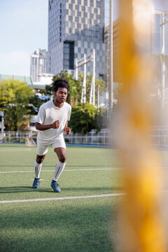 Rugby player sprinting on field