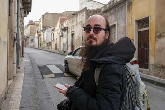 Tourist Holding Map on Quiet European Street