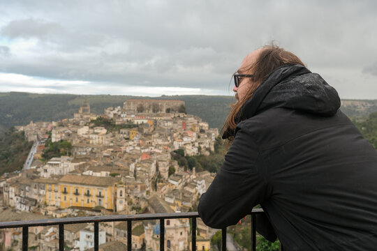 Man Looking Over Hill Town Viewpoint