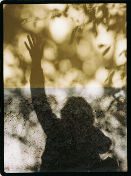 Raised hand shadow on wall