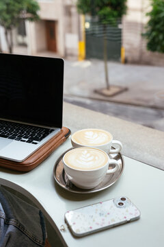 Coffee break with laptop at a caf&eacute; window