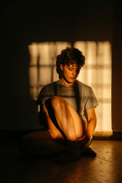 Woman resting on floor with shadows