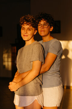 Two women embracing calmly at home