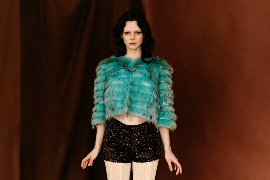 Model wearing turquoise fur coat