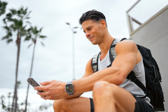 Man sitting outside checking phone
