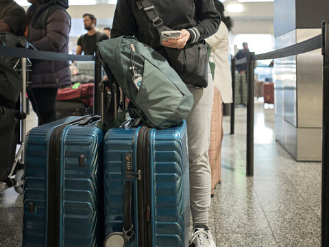 Waiting in Line  to Check-in at the Airport With Luggage