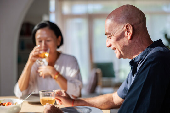 Couple enjoying a meal together in a bright room.