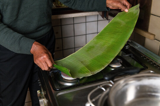 Softening banana leaf over fire for authentic Indonesian recipe