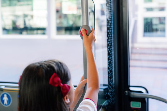 Girl requesting stop in bus. 