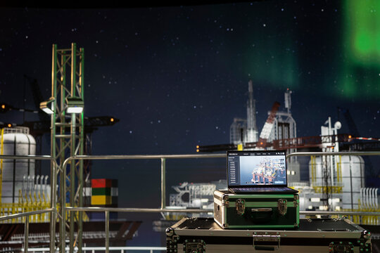 Laptop on offshore platform with system dashboard used for checking equipment status indicators. Notebook on drilling rig with digital monitoring panel app checking production levels
