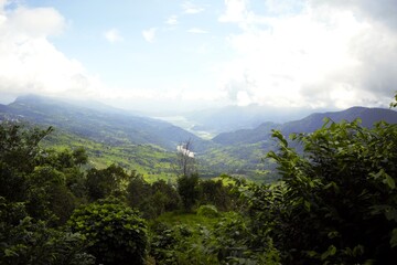 Obraz premium Panoramic green valley landscape in Annapurna region Nepal with mountains and clouds