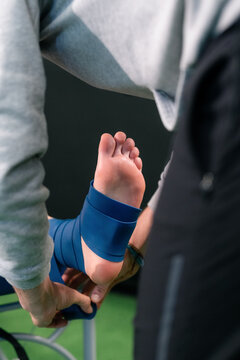 Athlete Receives Ankle Support During Physiotherapy Session