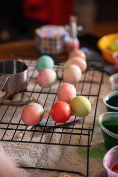 Dyed Easter eggs drying on a rack after being colored at home