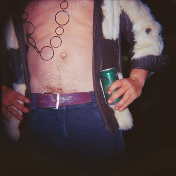 Man Wearing a Jacket and Holding a Drink dressed for 1970s Party
