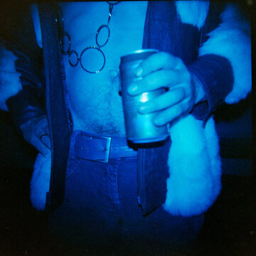 GuyHolding a Can While Wearing a 1970s outfit for party