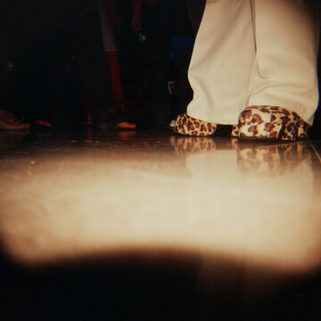 People Dancing in 1970s dress up costumes at fun party