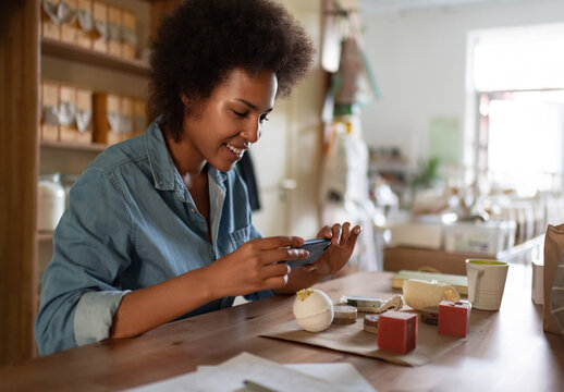 Cheerful black woman shooting natural cosmetic in store