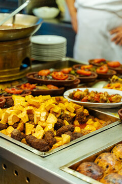 Fried potatoes and meatballs at a buffet