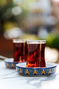 Two traditional tea glasses on a marble table