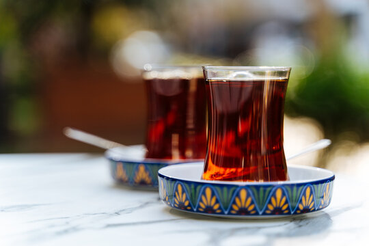 Two glasses of Turkish tea served on patterned saucers