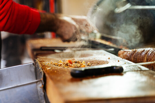 Street vendor preparing chopped meat at food stall