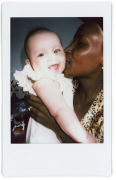 Mother kissing newborn baby