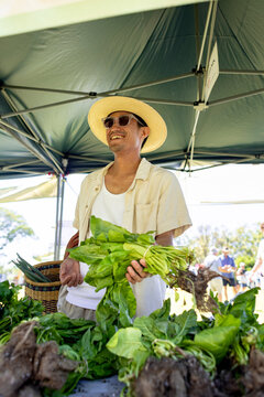 Man Smiling Holding Greens