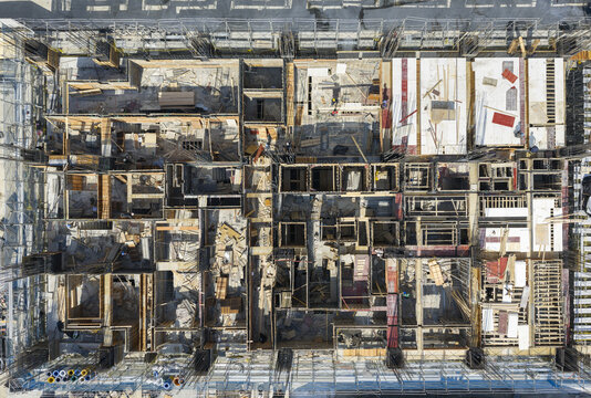 Aerial view of building construction and formwork with scaffolding, rebar, and wooden panels on a structural site in New Taipei, Taiwan.