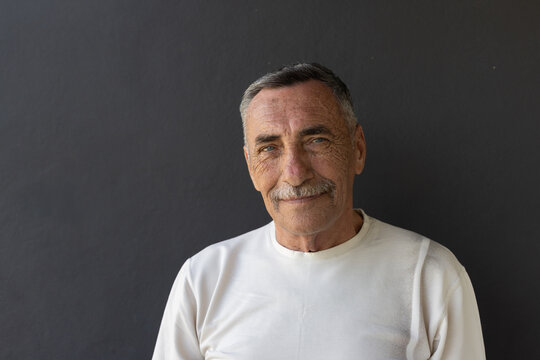 portrait of smiling elderly senior man  looking at camera